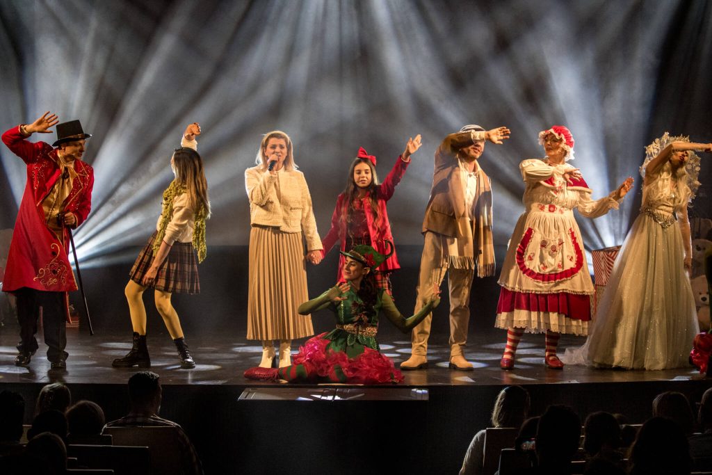 Siedmioro aktorów w bajkowych kostiumach podczas sceny zbiorowej spektaklu
